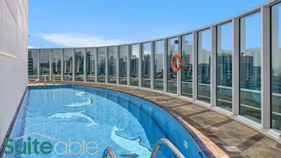 a swimming pool on the top of a building at Spacious refurbished Studio steps away from metro in Dubai