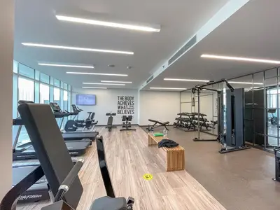 a gym with treadmills and exercise equipment in a building at Breathtaking Elegance 1Bedroom in Emaar Beachfront in Dubai