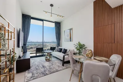a living room with a table and a couch at Luxury 1BR at Binghatti Onyx JVC in Dubai