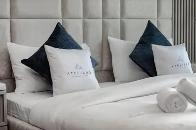 a bed with four pillows on top of it at Luxury 1BR at Binghatti Onyx JVC in Dubai