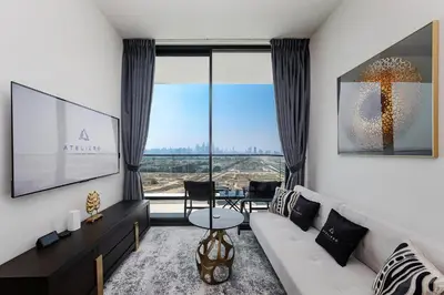a living room with a white couch and a large window at Luxury 1BR at Binghatti Onyx JVC in Dubai