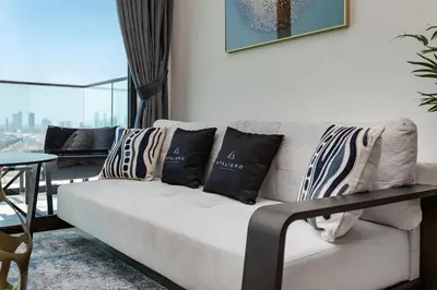 a living room with a couch with pillows on it at Luxury 1BR at Binghatti Onyx JVC in Dubai