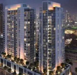 a group of tall buildings in a city at night at Hideaway in Downtown in Dubai