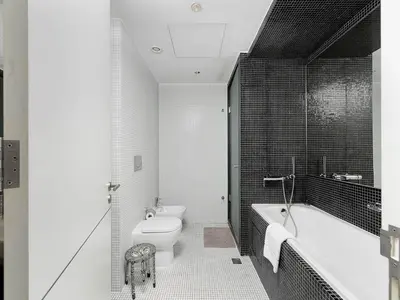 a bathroom with a tub and a toilet and a sink at Short stay Limestone House DIFC 2 bedrooms in Dubai