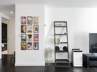a room with a white wall with pictures on it at Short stay Limestone House DIFC 2 bedrooms in Dubai