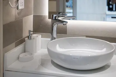 a bathroom sink with a white bowlasteryasteryasteryasteryasteryasteryasteryasteryastery at Seven Palm Apartment with Private Beach Access and Infinity Pool in Dubai