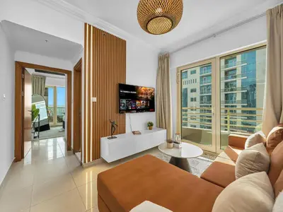 a living room with a couch and a tv at Luxurious Home in the heart of Dubai Marina in Dubai