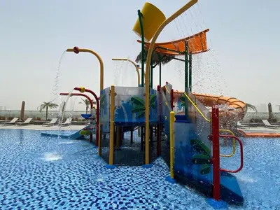 a water park with a water slide in a pool at Private Apartment in Novotel JVT Comfort for 4 Guests in Dubai