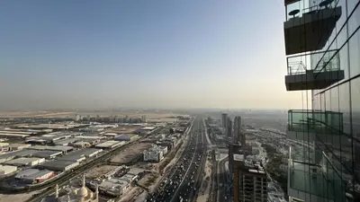 an aerial view of a city with cars parked at Private Apartment in Novotel JVT Comfort for 4 Guests in Dubai