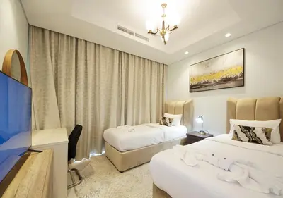 a hotel room with two beds and a chandelier at The Perfect Stay Paramount Business Bay 2BR in Dubai