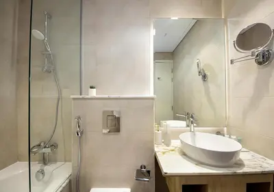 a bathroom with a sink and a shower and a mirror at The Perfect Stay Paramount Business Bay 2BR in Dubai