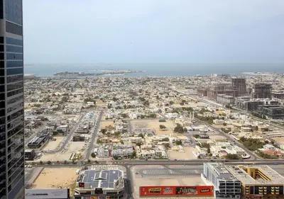 an aerial view of a city with buildings and the ocean at The Perfect Stay Paramount Business Bay 2BR in Dubai
