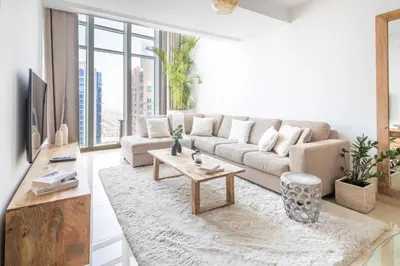 a living room with a couch and a table at Frank Porter - Laguna Tower in Dubai