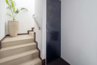 a stairwell with a plant in a vase at Frank Porter - Laguna Tower in Dubai