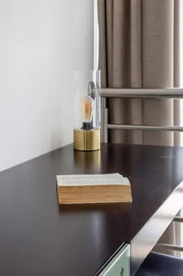 a desk with a book and a keyboard on it at Frank Porter - Laguna Tower in Dubai