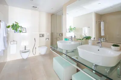 a bathroom with two sinks and a toilet at Frank Porter - Laguna Tower in Dubai