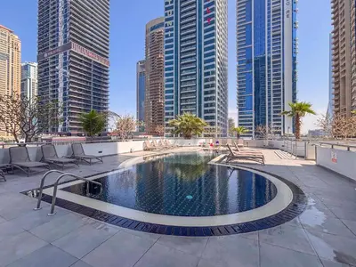 a pool in the middle of a city with tall buildings at Frank Porter - Laguna Tower in Dubai