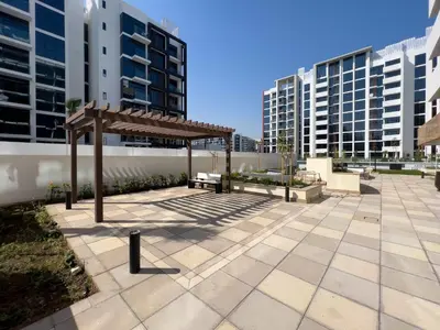 a pavilion in a courtyard with tall buildings at Frank Porter - Azizi Riviera 26 in Dubai