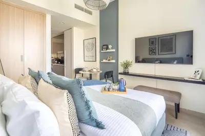 a bedroom with a bed and a living room at Frank Porter - Azizi Riviera 26 in Dubai