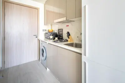 a kitchen with a sink and a washing machine at Frank Porter - Azizi Riviera 26 in Dubai
