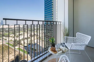 a balcony with a table and chairs and a view of a city at Frank Porter - Downtown Views II in Dubai