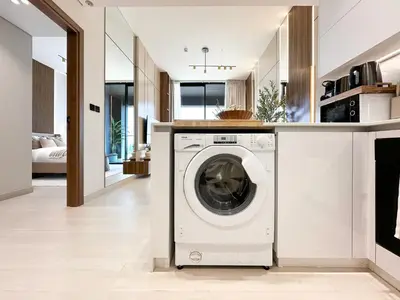 a white washer and dryer in the kitchen of a house at Trophy-Cultivate Retreat with Statement Design in Dubai