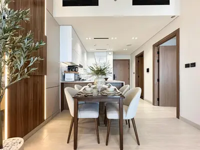 a kitchen and dining room with a table and chairs at Trophy-Cultivate Retreat with Statement Design in Dubai