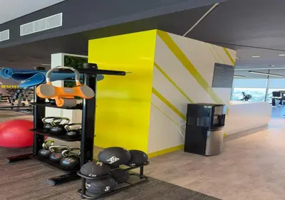 a gym with a yellow wall and some boxing equipment at Aykon city 2BHK beach city view in Dubai