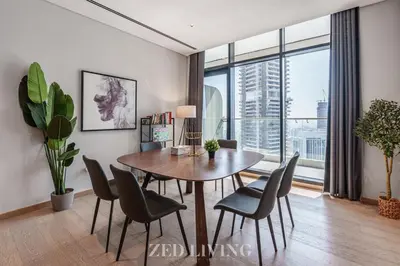 a dining room with a table and chairs and a large window at RP Heights - Luxe 2BR with Burj Khalifa View - Zed Living in Dubai