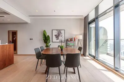 a dining room with a table and chairs at RP Heights - Luxe 2BR with Burj Khalifa View - Zed Living in Dubai