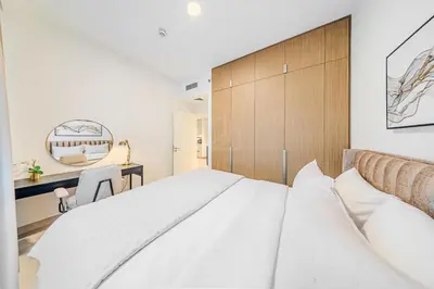 a bedroom with a large bed and a mirror at Elegant 1 Bedroom in Orchid at Creek Beach in Dubai