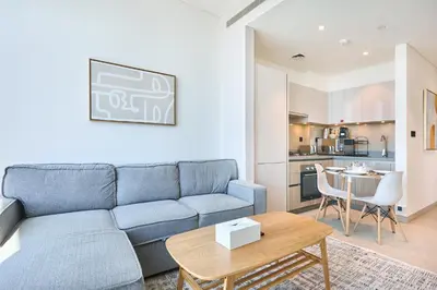 a living room with a blue couch and a table at STAY BY LATINEM Luxury 1BR Holiday Home W 3516 Near Burj Khalifa in Dubai