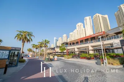 a city street with palm trees and tall buildings at LUX The Dubai Eye View JBR Studio in Dubai