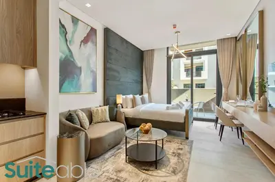 a living room with a couch and a table at Urban Retreat Studio in The Autograph JVC in Dubai
