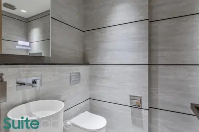 a bathroom with a toilet and a sink at Urban Retreat Studio in The Autograph JVC in Dubai