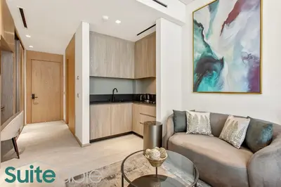 a living room with a couch and a table at Urban Retreat Studio in The Autograph JVC in Dubai