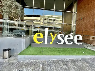 a large yellow sign on the side of a building at Homes2Retreat - Stylish Studio Gym & Pool, JVC Dubai in Dubai