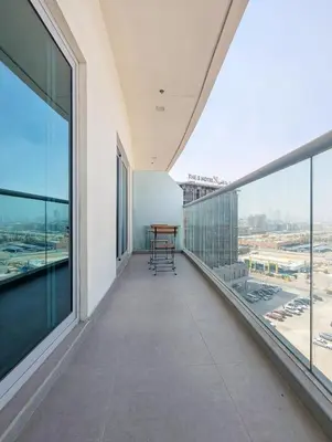 an empty balcony with a view of an airport at Stylish Fully Furnished 1BH Apartment Close by Dubai Science Park, Dubai Miracle Garden and Butterfly Garden in Dubai