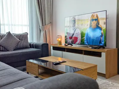 a living room with a flat screen tv at Stylish Fully Furnished 1BH Apartment Close by Dubai Science Park, Dubai Miracle Garden and Butterfly Garden in Dubai