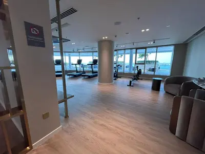 an office with a gym with treadmills and chairs at Beach View 1BR at Beachfront 50 Off Eid Offer in Dubai