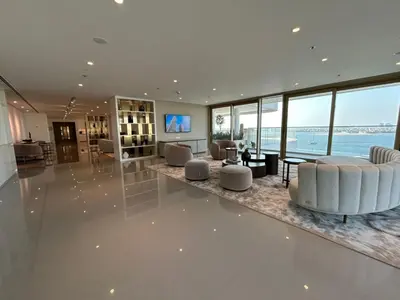 a large living room with white furniture and large windows at Beach View 1BR at Beachfront 50 Off Eid Offer in Dubai