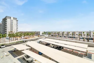 an overhead view of a parking lot with white benches at GuestReady - Modern studio with balcony in Dubai in Dubai