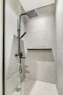 a shower with a glass door in a bathroom at GuestReady - Modern studio with balcony in Dubai in Dubai