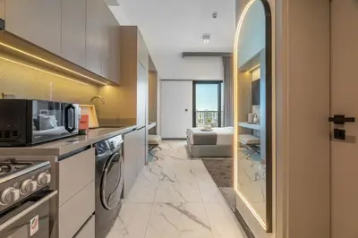 a kitchen with a microwave and a stove top oven at GuestReady - Modern studio with balcony in Dubai in Dubai