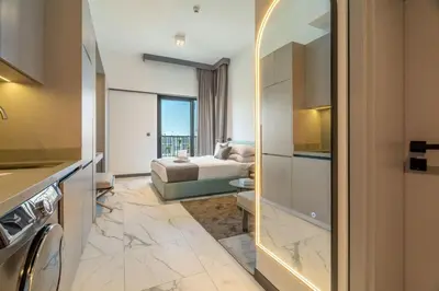 a room with a bedroom with a bed and a bathroom at GuestReady - Modern studio with balcony in Dubai in Dubai
