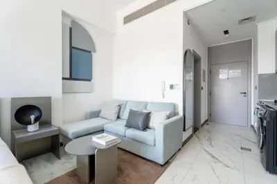 a living room with a couch and a table at GuestReady - Modern studio with balcony in Dubai in Dubai
