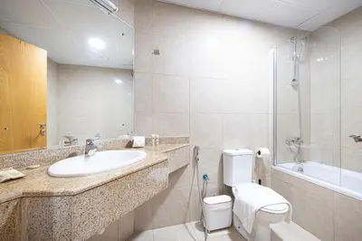 a bathroom with a sink and a toilet and a tub at Prime Location - 2BR with Spectacular Sea View in Dubai