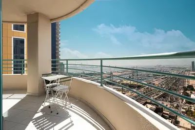 a balcony with a table and a view of a city at Prime Location - 2BR with Spectacular Sea View in Dubai