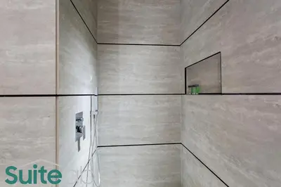 a bathroom with a wall with a mirror on it at Studio in The Autograph JVC w amazing facilities in Dubai
