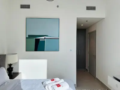 a bedroom with a bed with two towels on it at Your Home away from Home in Dubai